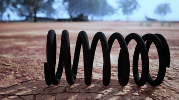 Black spring on a dirt field photo