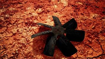 A propeller on a vibrant red dirt field photo