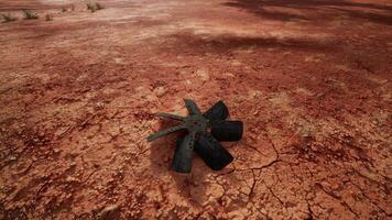 A large propeller in a rustic outdoor setting photo