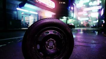 A tire sitting on the side of a road at night photo