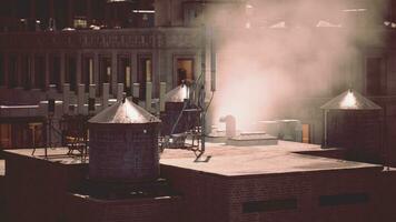 Smoke rising from a chimney on the roof of a building photo