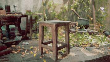 An abandoned room with a wooden stool on a worn stone floor photo