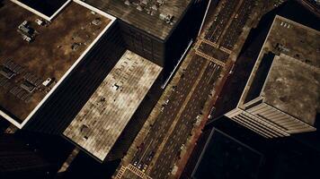 A bird's eye view of a bustling city street surrounded by towering buildings photo