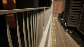 A building with a scenic view of the city captured through a close-up of a fence photo