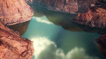 A serene mountain lake reflecting the surrounding peaks photo