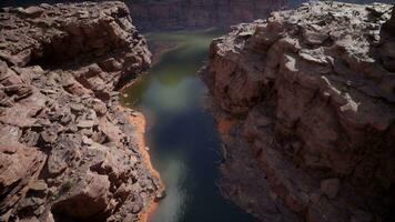 A serene lake nestled among towering cliffs and boulders photo