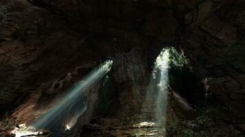 A mesmerizing beam of light illuminating a mystical cave in the mountains photo