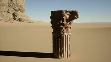 A pillar in the middle of a desert photo