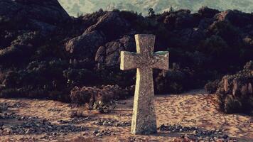 A solitary stone cross in the vast desert landscape photo