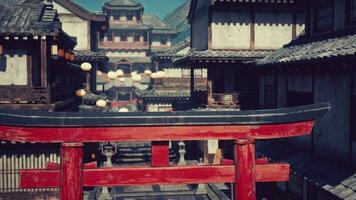 A red gate in front of a row of buildings photo