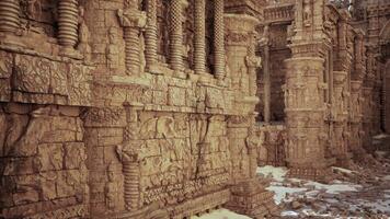 A intricately carved stone wall in a temple adorned with ornamental designs photo