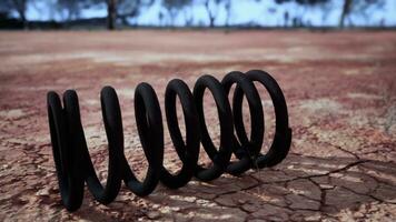 Black spring on a dirt field photo