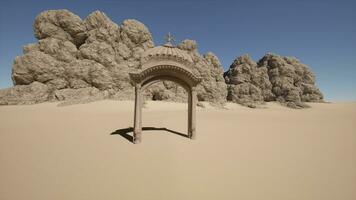 A small arch in the middle of a desert photo