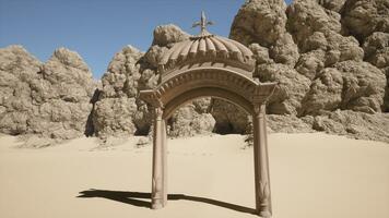 A stone structure with a cross on top of it photo