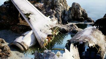 Aged aircraft on rocky island cliff face photo