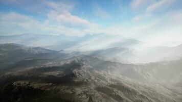 majestic mountain range covered in mystical fog photo