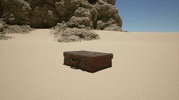 A piece of luggage sitting in the middle of a desert photo