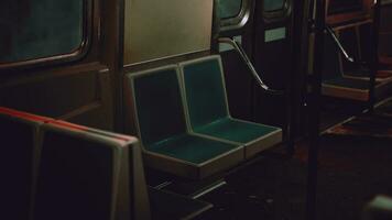 A green seat on a metro train next to a window photo