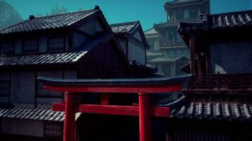 A red gate stands in front of a row of buildings photo