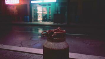 A bottle sitting on the side of a street photo