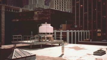 A white tank on a rooftop surrounded by tall buildings photo