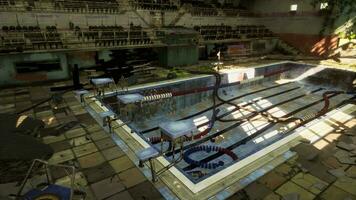 An abandoned swimming pool in an empty and decaying building photo