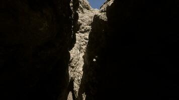 A narrow passage between two large rocks photo