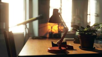 A table with a lamp and a potted plant on it photo