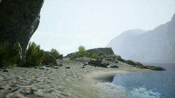 beach landscape with rocky formations and crystal clear water photo