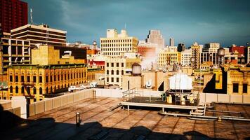 A panoramic cityscape taken from a rooftop with steam rising from the buildings photo