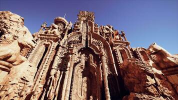 A towering building adorned with ornate statues on its walls photo