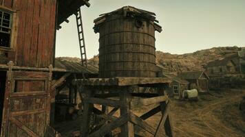 An antique wooden building with a charming water tower beside it photo