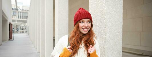 Happy redhead girl, tourist going around town, exploring sighsteeing places in city, backpacking around europe, enjoys travelling photo