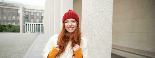 Happy redhead girl, tourist going around town, exploring sighsteeing places in city, backpacking around europe, enjoys travelling photo