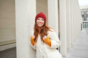 Happy redhead girl, tourist going around town, exploring sighsteeing places in city, backpacking around europe, enjoys travelling photo