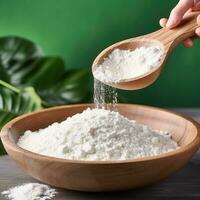 Collagen powder in wooden bowl on natural green background. AI Generated photo