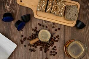 Top view, coffee cup, coffee flavored bread slices with coffee beans around photo