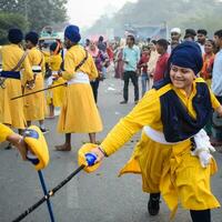 Delhi, India, October 2, 2023 - Sikhs display gatka and martial arts during annual Nagar Kirtan, Traditional, procession on account of birthday of Guru Nanak Dev ji, Nagar Kirtan in East Delhi area photo