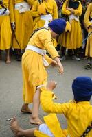 Delhi, India, October 2, 2023 - Sikhs display gatka and martial arts during annual Nagar Kirtan, Traditional, procession on account of birthday of Guru Nanak Dev ji, Nagar Kirtan in East Delhi area photo