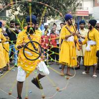 Delhi, India, October 2, 2023 - Sikhs display gatka and martial arts during annual Nagar Kirtan, Traditional, procession on account of birthday of Guru Nanak Dev ji, Nagar Kirtan in East Delhi area photo