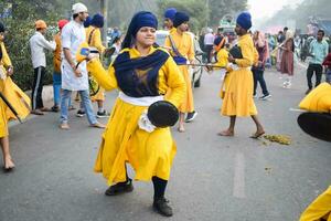 Delhi, India, October 2, 2023 - Sikhs display gatka and martial arts during annual Nagar Kirtan, Traditional, procession on account of birthday of Guru Nanak Dev ji, Nagar Kirtan in East Delhi area photo