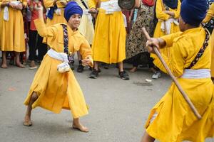 Delhi, India, October 2, 2023 - Sikhs display gatka and martial arts during annual Nagar Kirtan, Traditional, procession on account of birthday of Guru Nanak Dev ji, Nagar Kirtan in East Delhi area photo