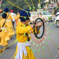 Delhi, India, October 2, 2023 - Sikhs display gatka and martial arts during annual Nagar Kirtan, Traditional, procession on account of birthday of Guru Nanak Dev ji, Nagar Kirtan in East Delhi area photo