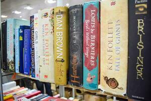 New Delhi, India, September 09 2023 - Variety of Books on shelf inside a book-stall at Delhi International Book Fair, Selection of books on display in Annual Book Fair. photo