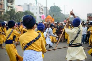 Delhi, India, October 2, 2023 - Sikhs display gatka and martial arts during annual Nagar Kirtan, Traditional, procession on account of birthday of Guru Nanak Dev ji, Nagar Kirtan in East Delhi area photo