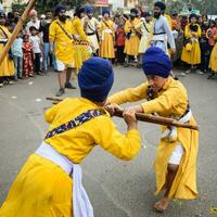 Delhi, India, October 2, 2023 - Sikhs display gatka and martial arts during annual Nagar Kirtan, Traditional, procession on account of birthday of Guru Nanak Dev ji, Nagar Kirtan in East Delhi area photo