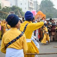 Delhi, India, October 2, 2023 - Sikhs display gatka and martial arts during annual Nagar Kirtan, Traditional, procession on account of birthday of Guru Nanak Dev ji, Nagar Kirtan in East Delhi area photo