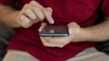 man's hand holding phone in home video