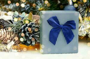 Christmas composition with Christmas tree branches, red tinsel, gift boxes and silver tinsel photo