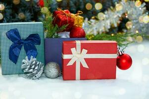 Christmas composition with Christmas tree branches, red tinsel, gift boxes and silver tinsel photo